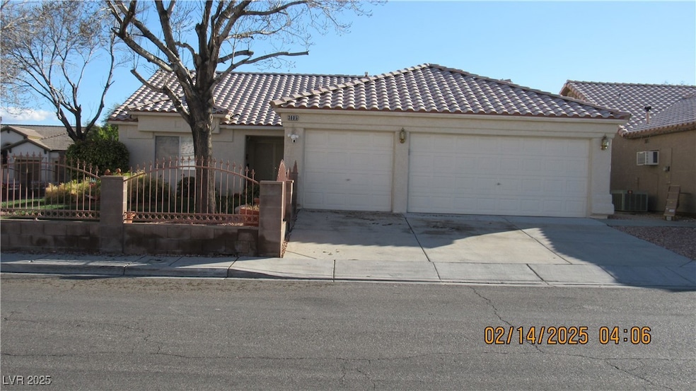 View of front facade featuring a garage, driveway,