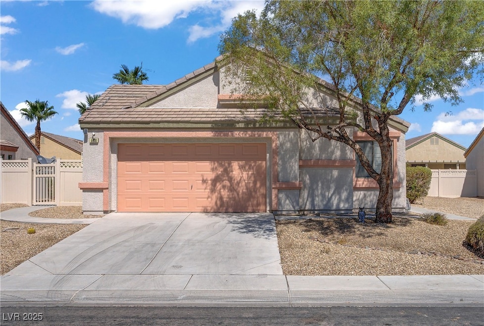 View of front of house with concrete driveway, a g