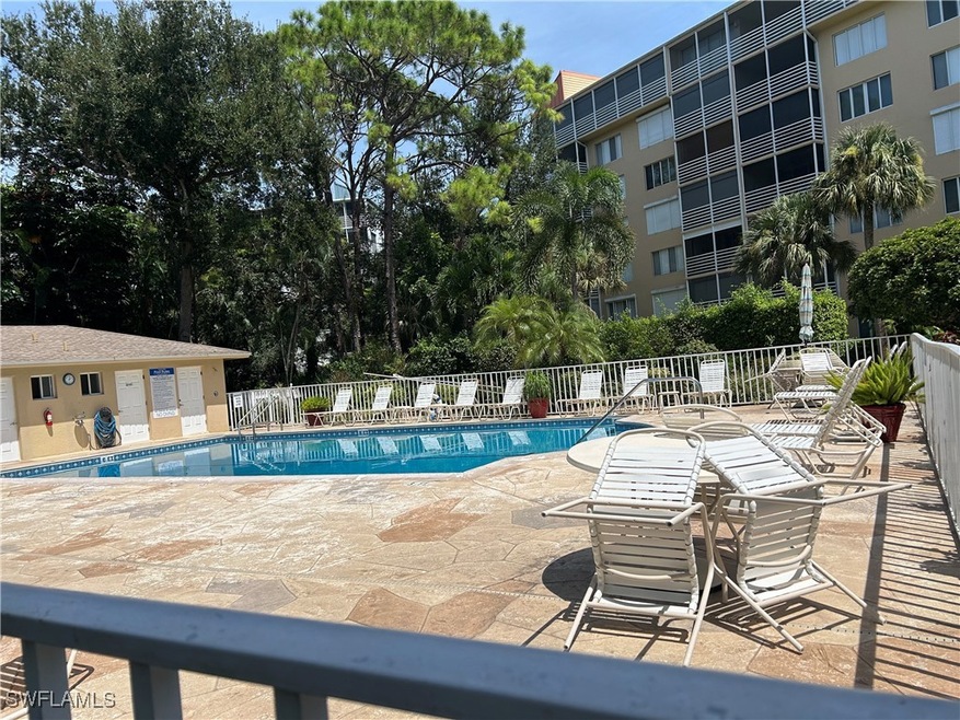 Community pool featuring fence and a patio area