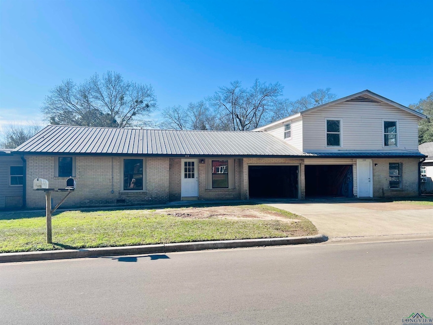 View of front of property with a garage and a fron