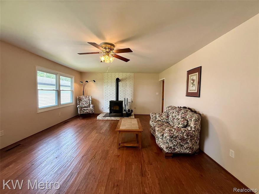 Rear view of house featuring a yard, a patio area, a garage, and an outbuilding