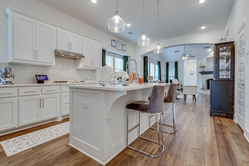 Kitchen featuring decorative light fixtures, wood-