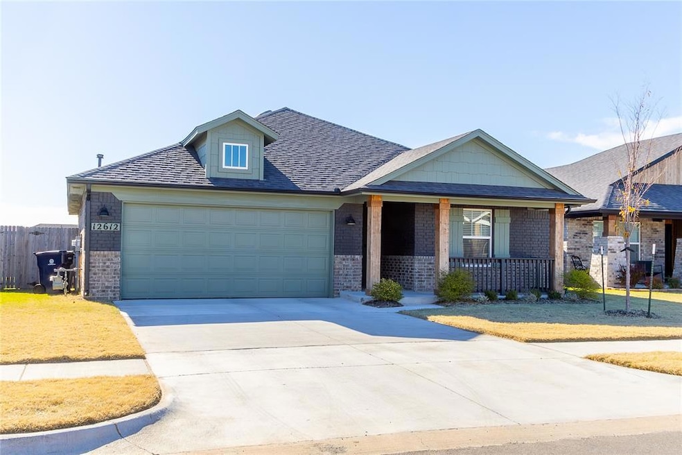 View of front of property featuring a garage and covered porch