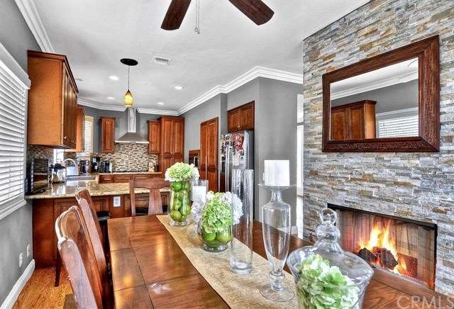 Unit A Dining room with fireplace and kitchen.
