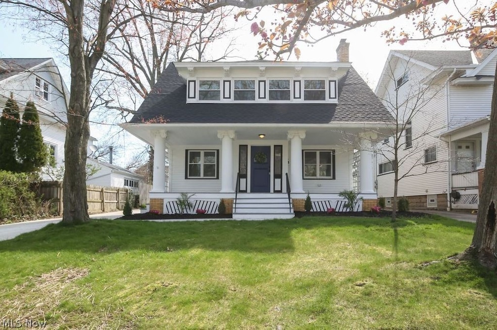 Colonial Home, with covered front porch with front and side stairs.