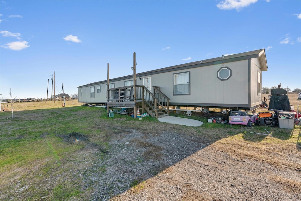 Back of property with stairs, a yard, and a wooden deck