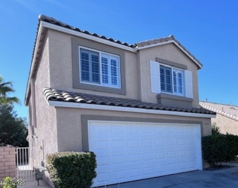 View of property exterior featuring an attached ga