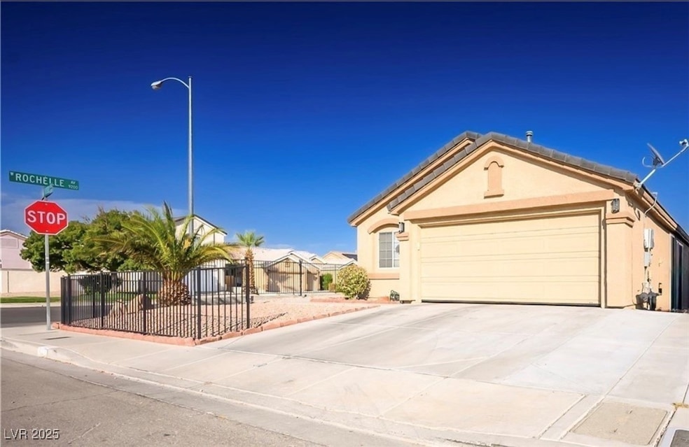 Ranch-style home featuring an attached garage, stu