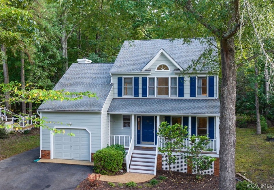 View of front facade with garage and a porch