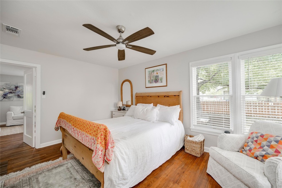 Bedroom with baseboards, wood finished floors, an
