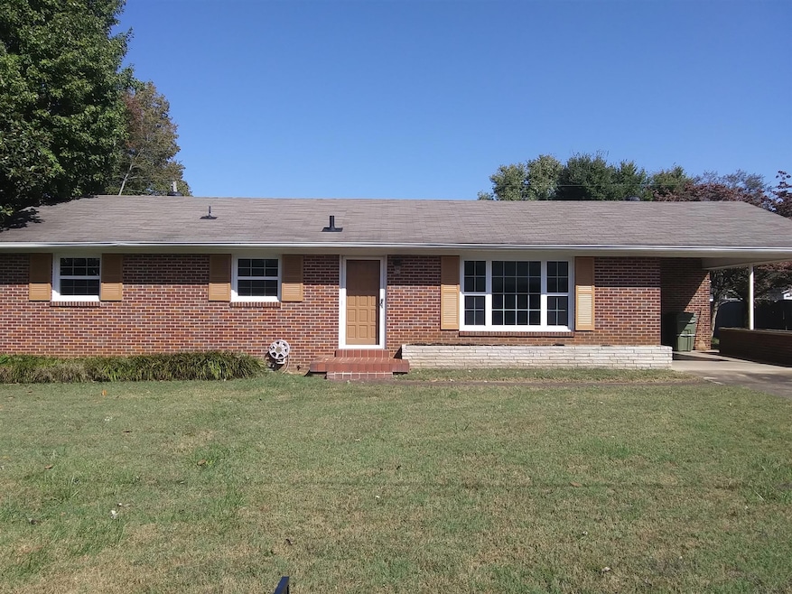 All brick with carport and large yard