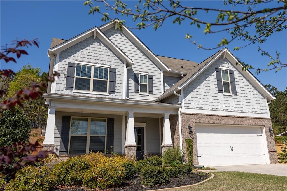 Craftsman-style house with an attached garage, dri