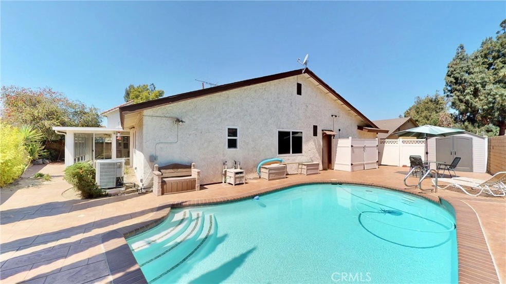 Pool Home with stamped contcrete, sun room, block walls and vinyl fencing!