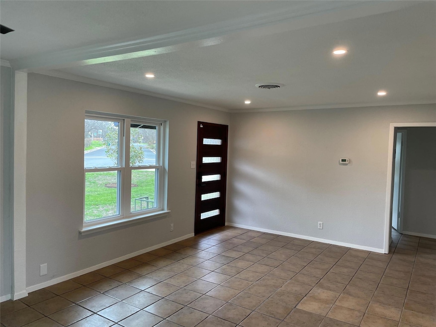 Empty room featuring ornamental molding, recessed