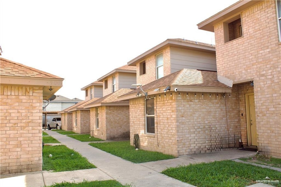 View of side of property with a shingled roof