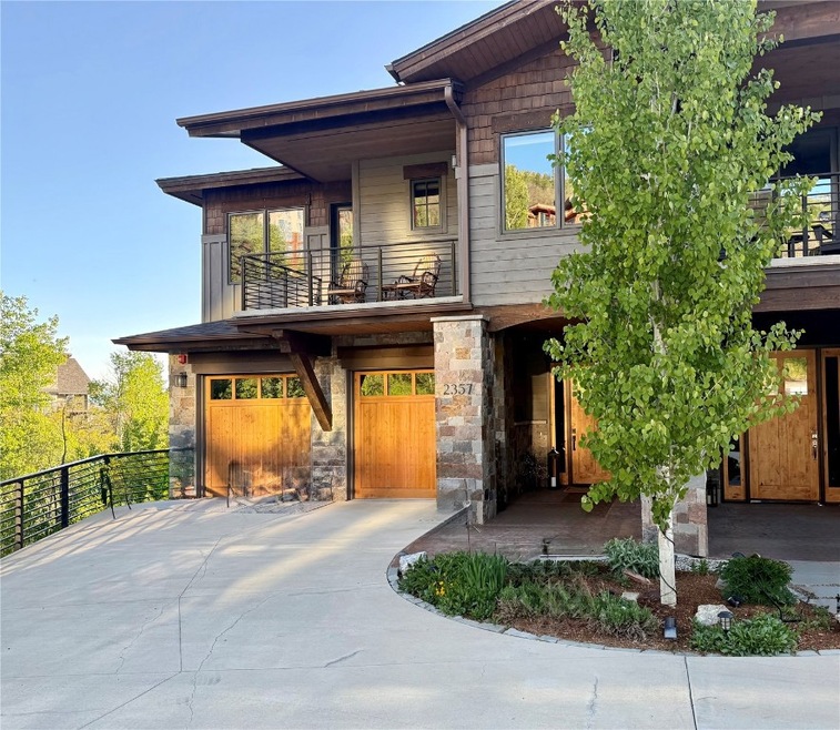 View of front of property featuring a balcony, con
