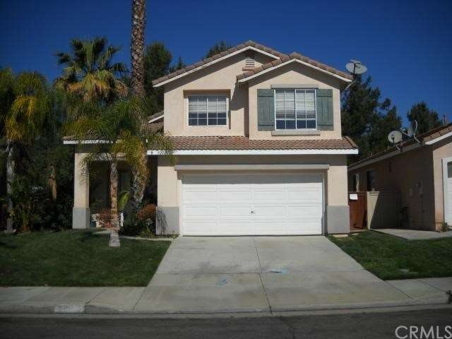 Front of House with Lush Landscaping and Mature Pa