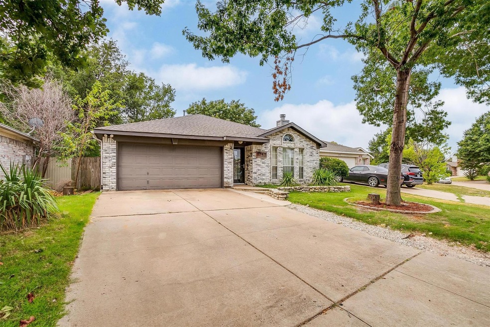 Single story home featuring a front lawn and a gar