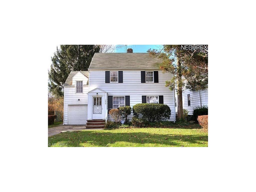 Classic colonial with shrubbery and black shutters
