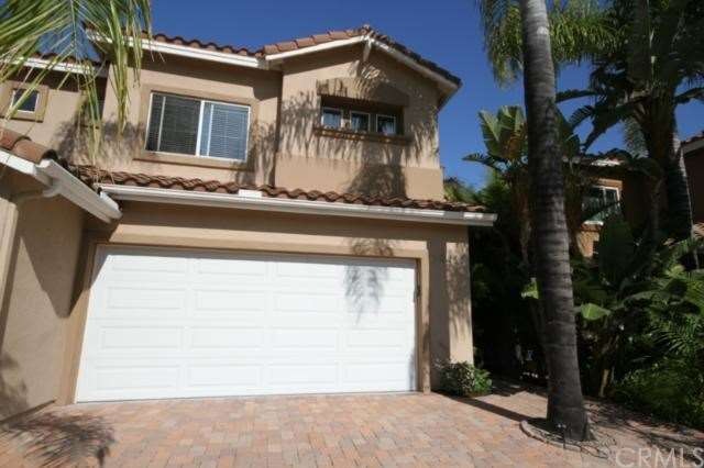 Front of home showing 2 car attached garage and dr