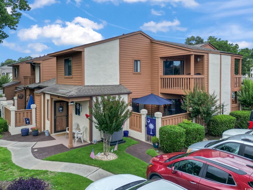 View of front of home featuring stucco siding and a shingled roof