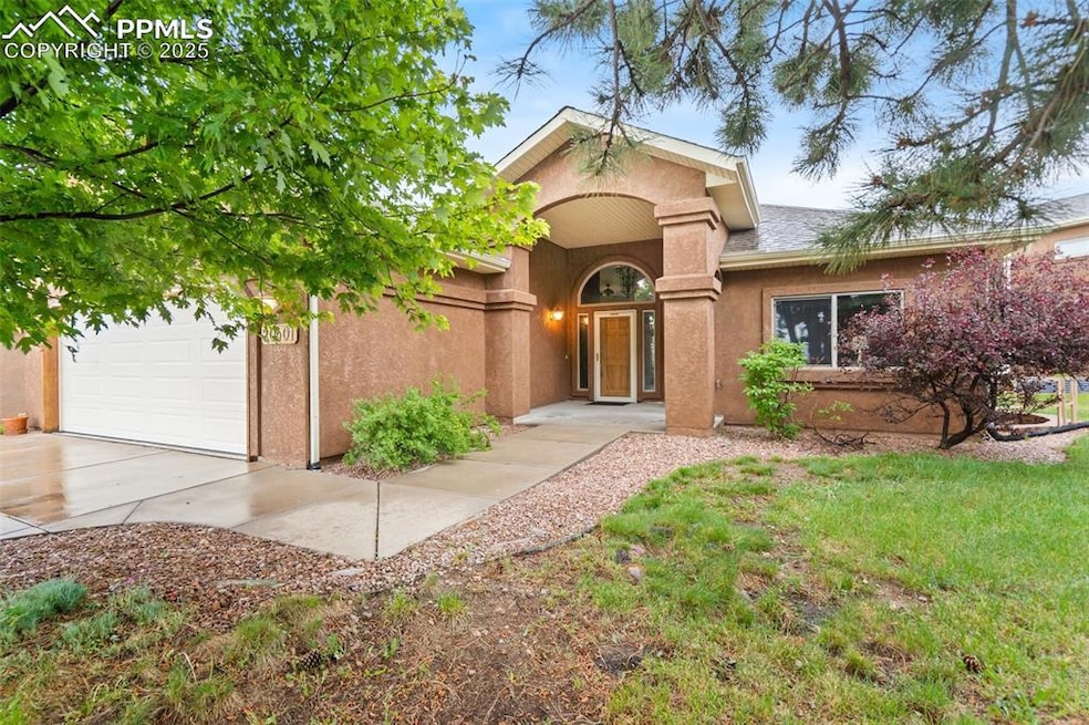 View of front of home featuring stucco siding, a garage, and concrete driveway