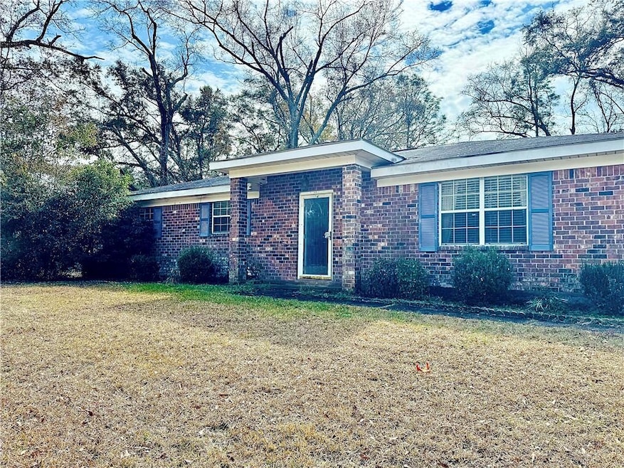 Single story home featuring a front lawn