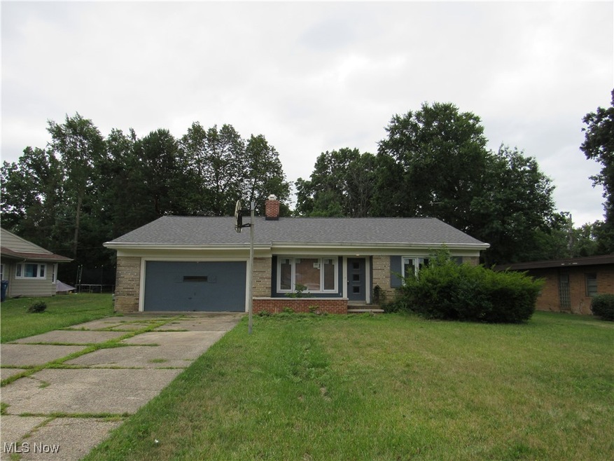Ranch-style home with a garage and a front yard