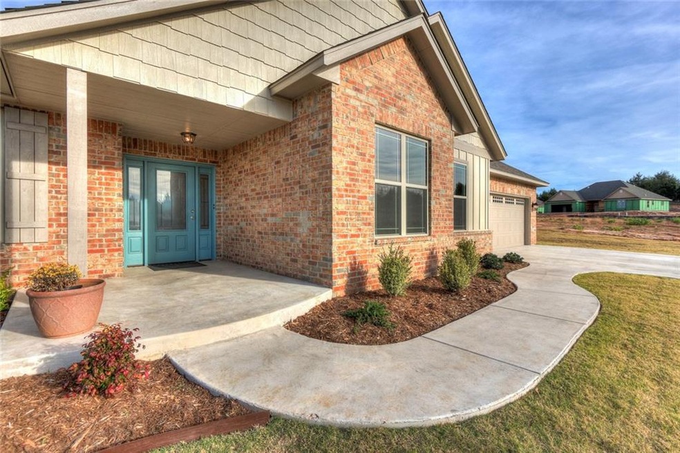 A welcoming entrance fully landscaped with a covered front porch to enjoy.