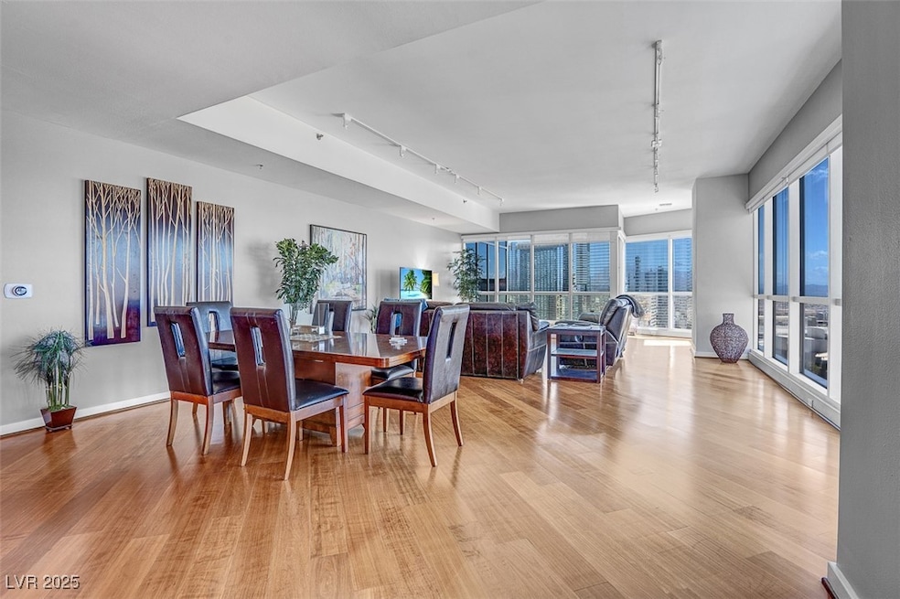 Dining room with rail lighting and light wood-type flooring