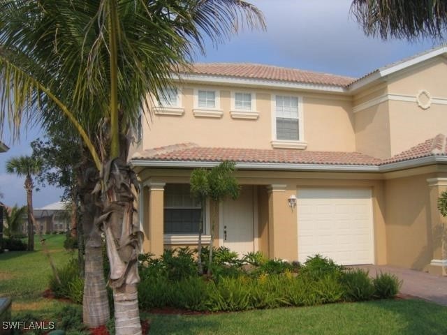 Mediterranean / spanish-style house featuring a ga