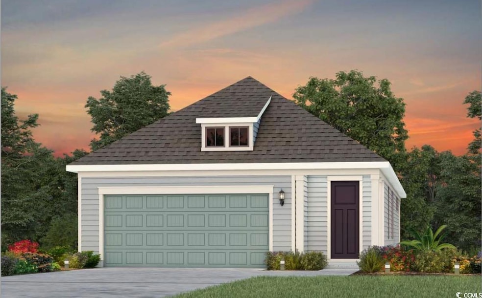 View of front facade featuring a shingled roof, an outbuilding, and a detached garage
