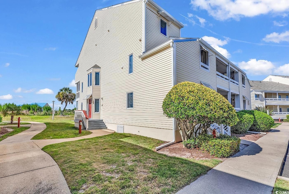 View of side of home featuring a yard