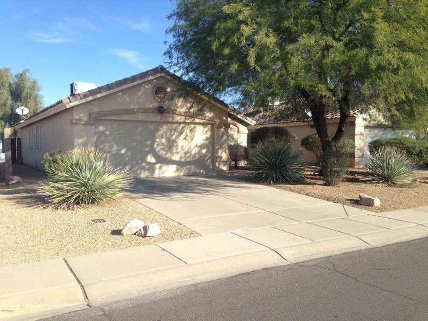 Front of home shaded by mesquite tree