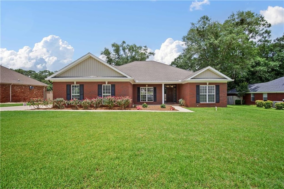 Ranch-style home featuring a front yard and brick siding