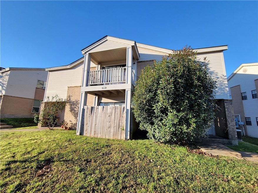 View of front of property with a front lawn, brick