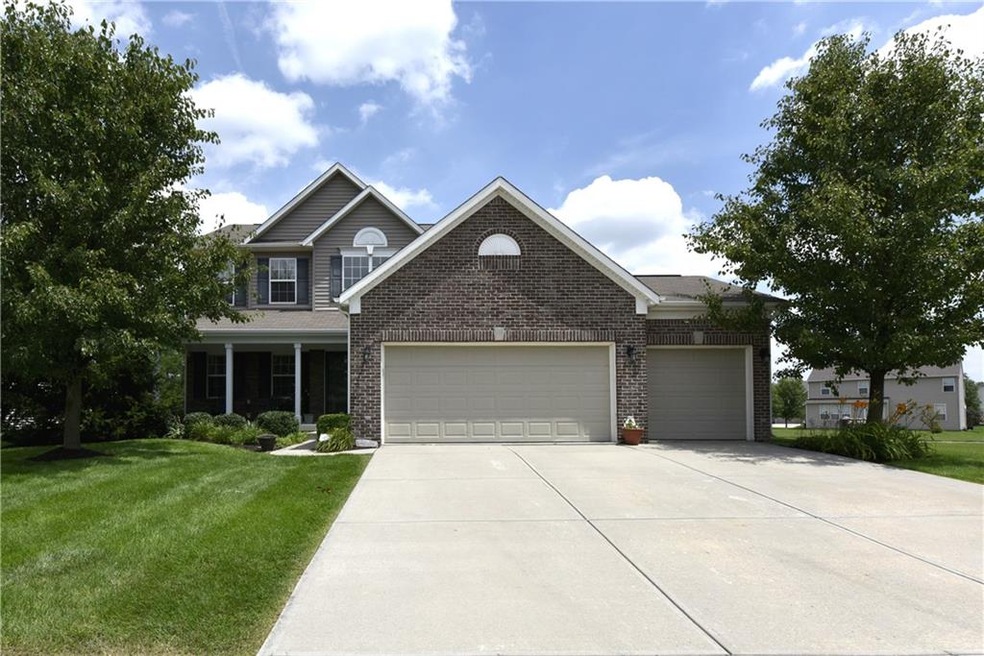 Wonderful welcome porch greets you at this former model in Popular Mill Grove!