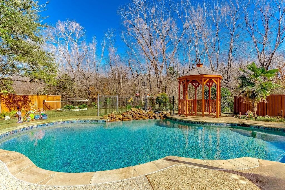 Unwind in this landscaped backyard with pool, wate