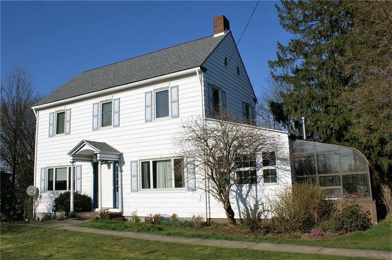 This charming colonial home features a sunroom, on