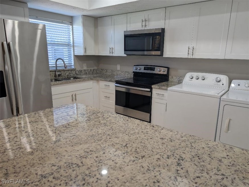 Kitchen with appliances with stainless steel finis