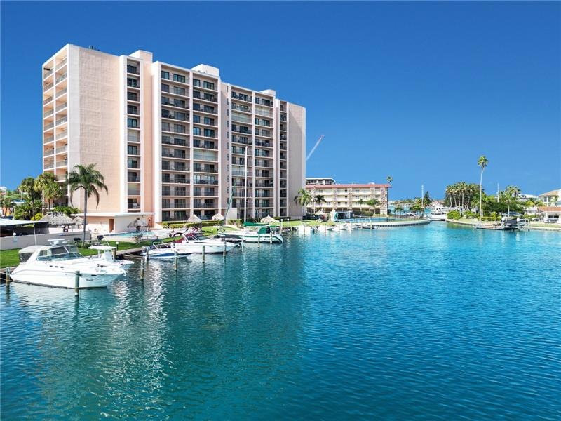 Resort style building with heated pool, spa, restrooms, sauna, kayak storage, tennis, shuffleboard, marina and tiki bar.