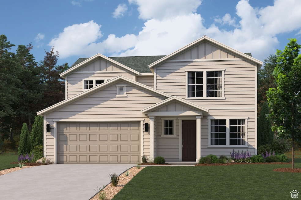 View of front of home featuring board and batten siding, driveway, and a front yard