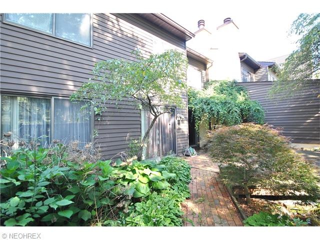 Perennial gardens and brick walkway enhance the pr