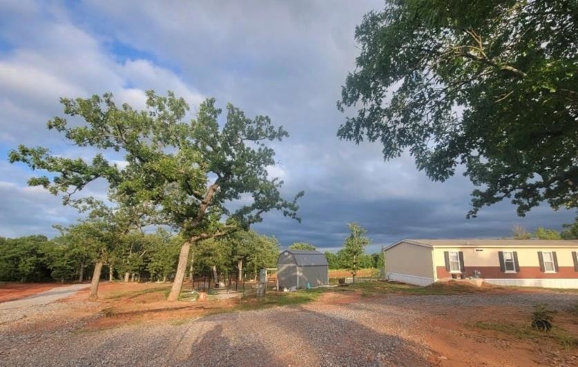 View of dirt / gravel driveway with an exterior st