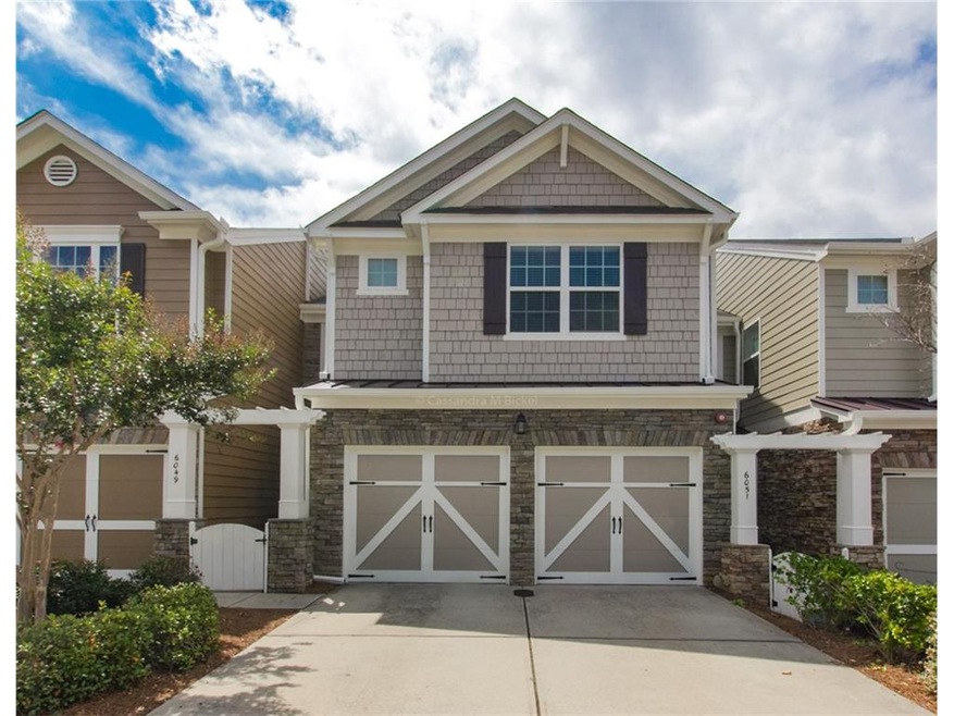 Front of 2 story townhouse with 2 car garage.
