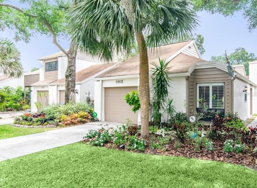 Front. One-car garage and driveway with side walkw