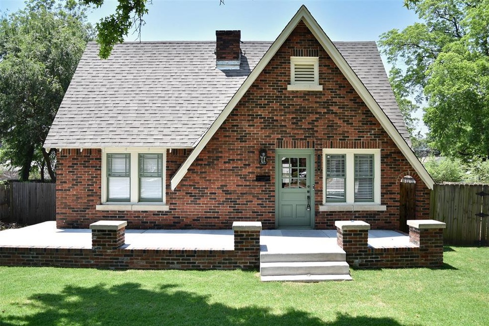 Tudor-style house with a front yard