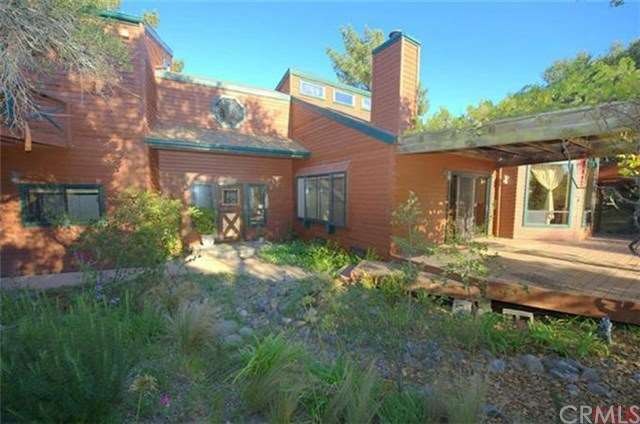 Main house is beautifully landscaped, features a d