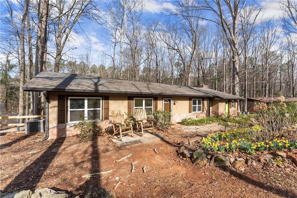 View of front of home with a patio, stucco siding,