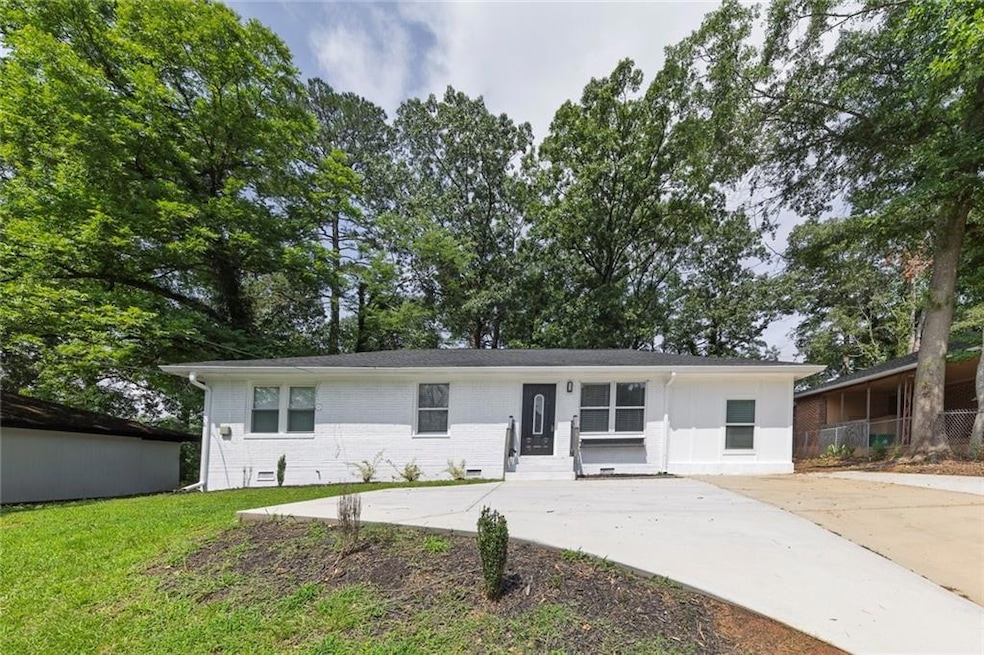 View of front of property with a front lawn and driveway